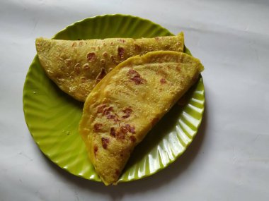 Beyaz Arkaplanda izole edilmiş bir tabakta Geleneksel Sarı Renk Dal Obbattu veya Holige Grubu