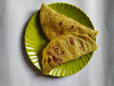 Beyaz Arkaplanda izole edilmiş bir tabakta Geleneksel Sarı Renk Dal Obbattu veya Holige Grubu