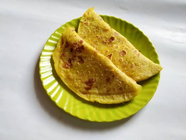 Beyaz Arkaplanda izole edilmiş bir tabakta Geleneksel Sarı Renk Dal Obbattu veya Holige Grubu