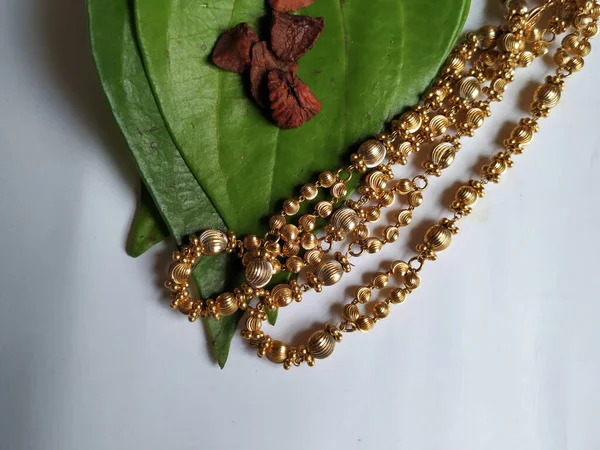 Antique Traditional Women Gold Chain with Betel Leaves and Areca Nut isolated on white background