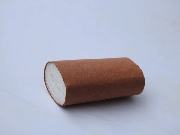 Closeup White Medical Cotton Bandage Roll Brown Paper Wrapping — Stock Photo, Image