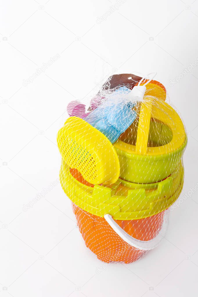 Set of plastic beach toys on white background