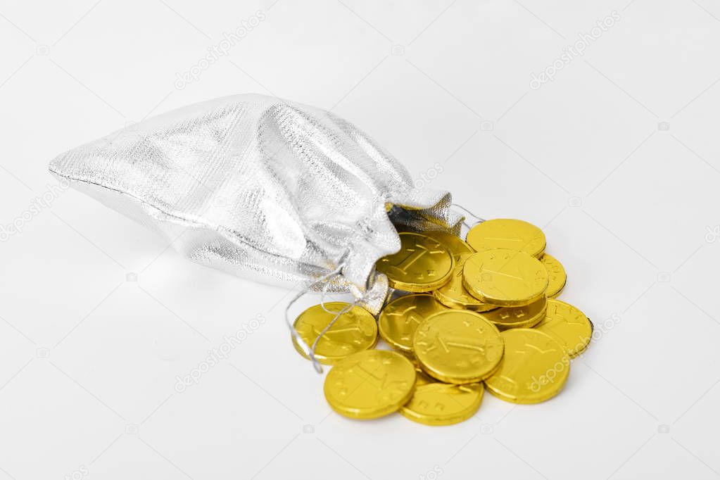 Money bag and gold coins falling from it. Concept of savings and the economy.