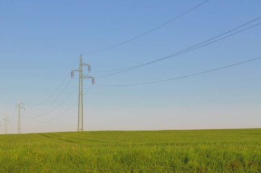 Güç hattı ve yeşil alan mavi gökyüzü ile