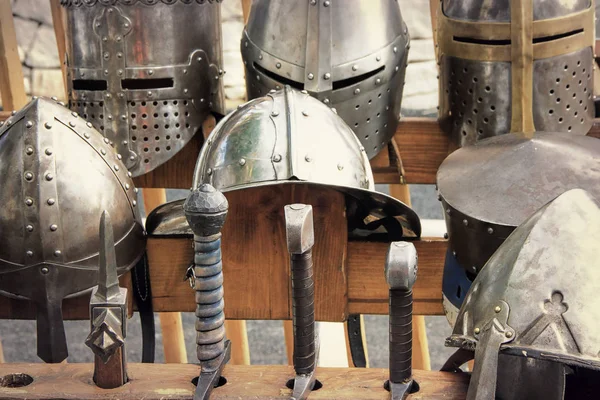 Medieval armors: helmets and swords — Stock Photo, Image