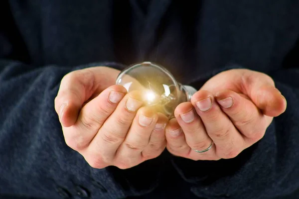 Man Suit Holding Light Bulb Inhis Palms Electric Power Concept — Stock Photo, Image