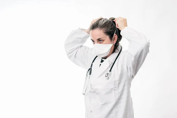 Kadın doktor koronavirüsü önlemek için maske takıyor.