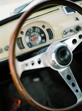 Tahta direksiyonlu sarı klasik bir arabanın penceresinden bakmak.