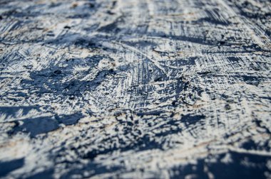 Doku arka planı. Bej taban siyah boya lekeleriyle kaplı. Yan görüş. Doku ve arkaplan