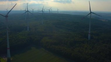 Almanya 'daki Berlichingen yakınlarındaki rüzgar türbinlerinin hava görüntüsü. Baharın ilerleyen saatlerinde bulutlu bir gökyüzüyle.