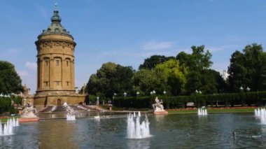 Yazın güneşli bir günde Almanya 'nın Mannheim kentindeki Friedrichsplatz' da su kulesi ve çeşme manzarası.