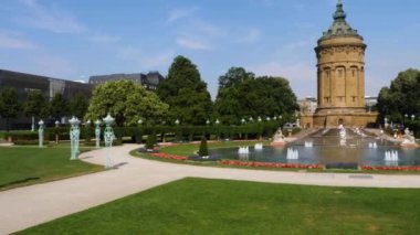 Yazın güneşli bir günde Almanya 'nın Mannheim kentindeki Friedrichsplatz' da su kulesi ve çeşme manzarası.