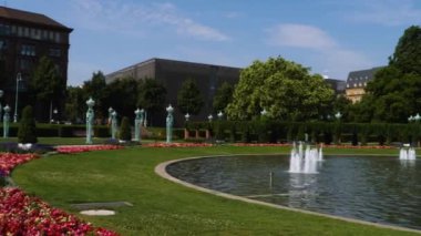 Yazın güneşli bir günde Almanya 'nın Mannheim kentindeki Friedrichsplatz' da su kulesi ve çeşme manzarası.