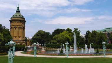 Yazın güneşli bir günde Almanya 'nın Mannheim kentindeki Friedrichsplatz' da su kulesi ve çeşme manzarası.