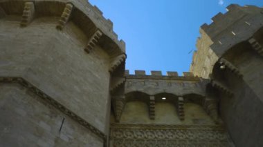 Camera tilts up and then back down at Towers of Quart, Christian city gate Valencia.