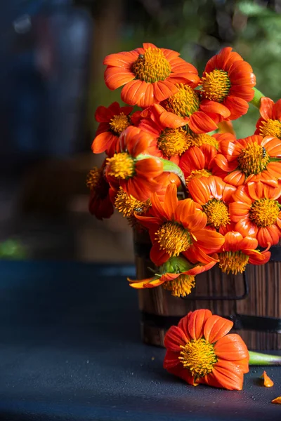 orange flowers arranged in rustic containers with natural light.