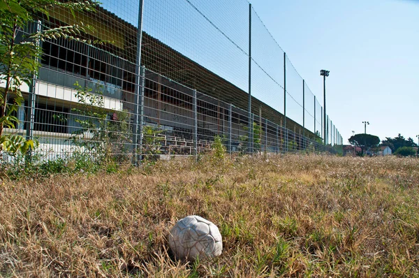 An old football on the pitch of the demolished Stade de la Palla football stadium in Valence, France.