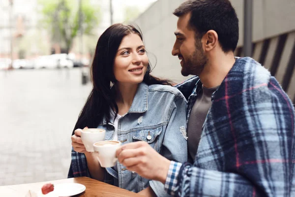 Guy with girl in cafe they eat dessert. Happy look. Romantic concept