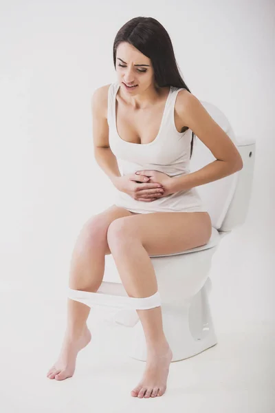 Woman on toilet isolated on white with panties — Stock Photo, Image