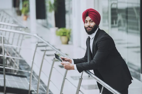 Young Indian bearded businessman in modern office — Stock Photo, Image