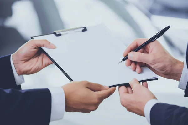 Close up Two Men Signing Contract at Car Showroom — Stock Photo, Image