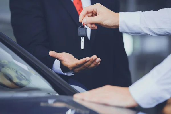 Close up of Dealer Giving Key to New Owner — Stock Photo, Image