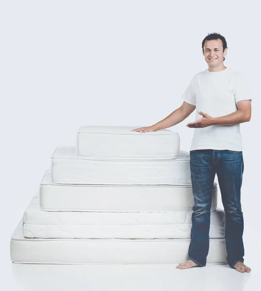 Smiling Man Standing Near Pyramid of Mattress — Stock Photo, Image