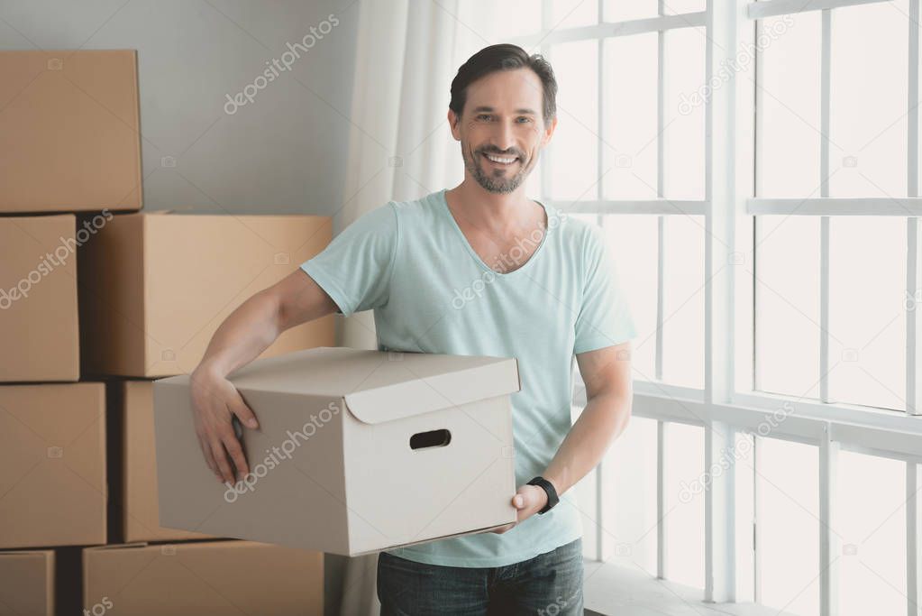 Young Bearded Guy with Cardboard Box in Hands.