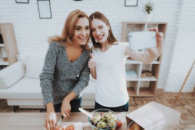Anne ve kızı mutfakta Selfie alarak gülümseyerek. Aile ilişkisi var. Tatil evde. Sağlıklı gıda ve yaşam tarzı kavramı. Birlikte yemek. Aile kavramı mutluluk. Fotoğraf çekme.