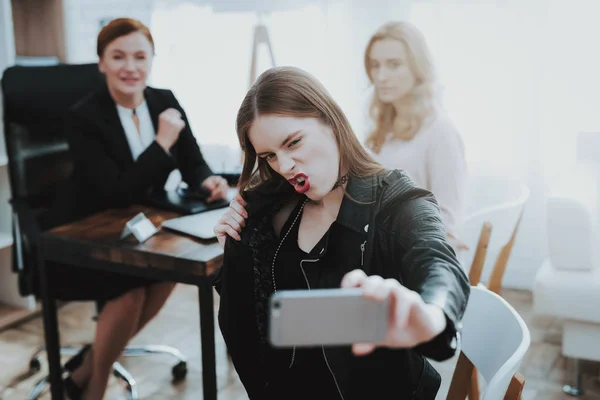 Teenage Girl in Leather Jacket with Upset Mother Taking Selfie in Psychologist Office. Punk in Lather Jacket. Puberty Problems. Conflict in Family. Communication Concept. Psychotherapy Concept.