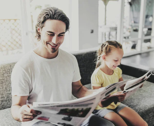 Pai e filha lendo jornais em casa . — Fotografia de Stock