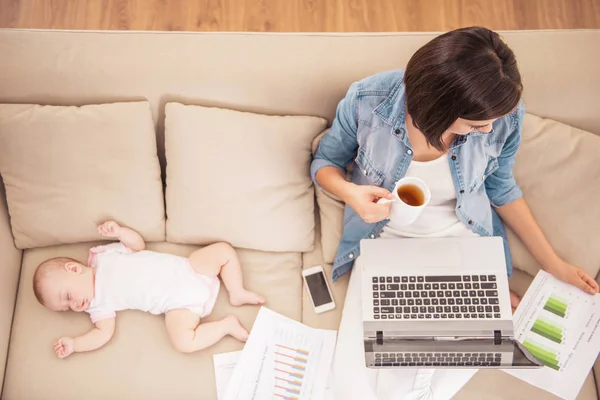 Top view. Young Woman with Child Working at Home. — Stock Photo, Image