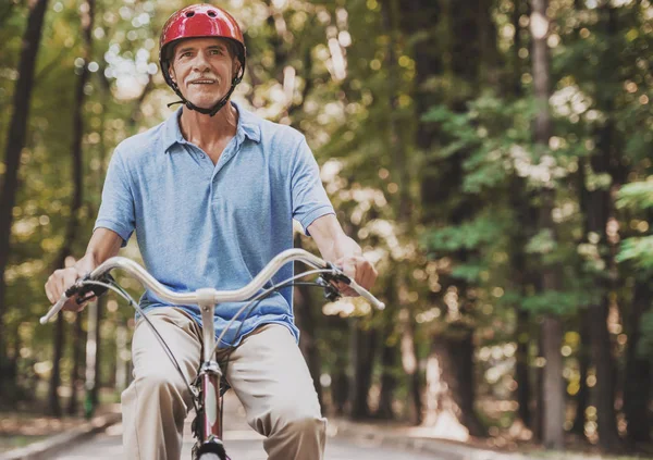 Gubbe som rider på cykel i Park i sommar . — Stockfoto