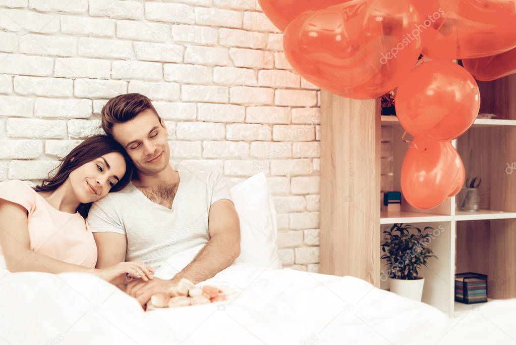 Happy Couple Are Lying In Bed At Valentine's Day. Love Each Other. Sweetheart's Holiday Concept. Feelings Showing. Celebrating Date. Young And Handsome. Eyes Closed Couple. Happy Together.