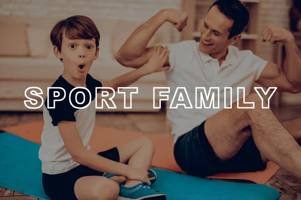 Father And Son Are Doing Gym. Sport Family. Healthy Lifestyle. Active Holiday. Exercises Clothes. Getting Better. Working Out At Home. Gym Carpet. Repeating Practice. Biceps Measuring.