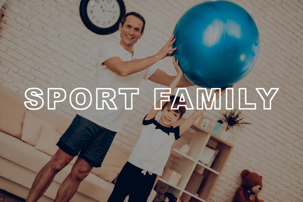Father And Son Are Exercising With Fitness Ball. Healthy Lifestyle. Active Holiday. Exercises Clothes. Getting Better. Working Out At Home. Sports Equipment. Repeating Practice. Body Shaping.