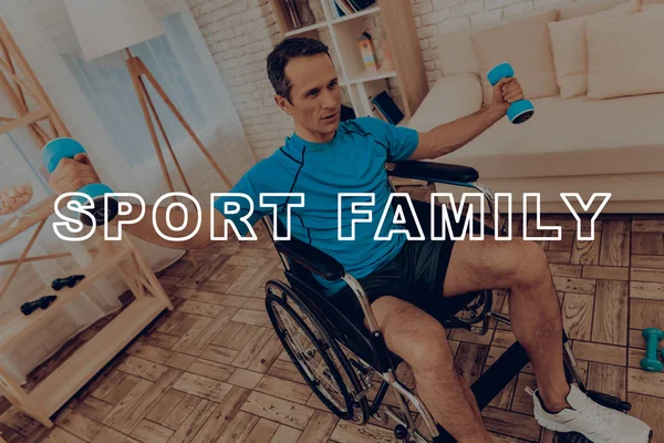 Man In Sport Clothes Work With Dumpbells In A Wheelchair. Healthy Lifestyle. Active Holiday. Sports Clothes. Getting Better. Working Out At Home. Gym Carpet. Repeat Practice. Body Exercises.