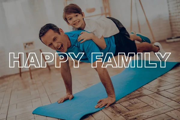 Father And Son Are Doing Gym. Sport Family. Healthy Lifestyle. Active Holiday. Exercises Clothes. Getting Better. Working Out At Home. Gym Carpet. Repeating Practice. Body Shaping.