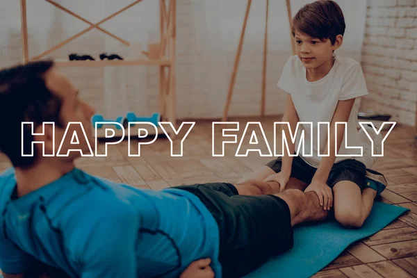 Father And Son Are Doing Gym. Sport Family. Healthy Lifestyle. Active Holiday. Exercises Clothes. Getting Better. Working Out At Home. Gym Carpet. Repeating Practice. Press Shaping.