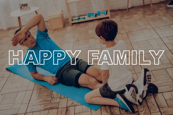 Father And Son Are Doing Gym. Sport Family. Healthy Lifestyle. Active Holiday. Exercises Clothes. Getting Better. Working Out At Home. Gym Carpet. Repeating Practice. Press Shaping.