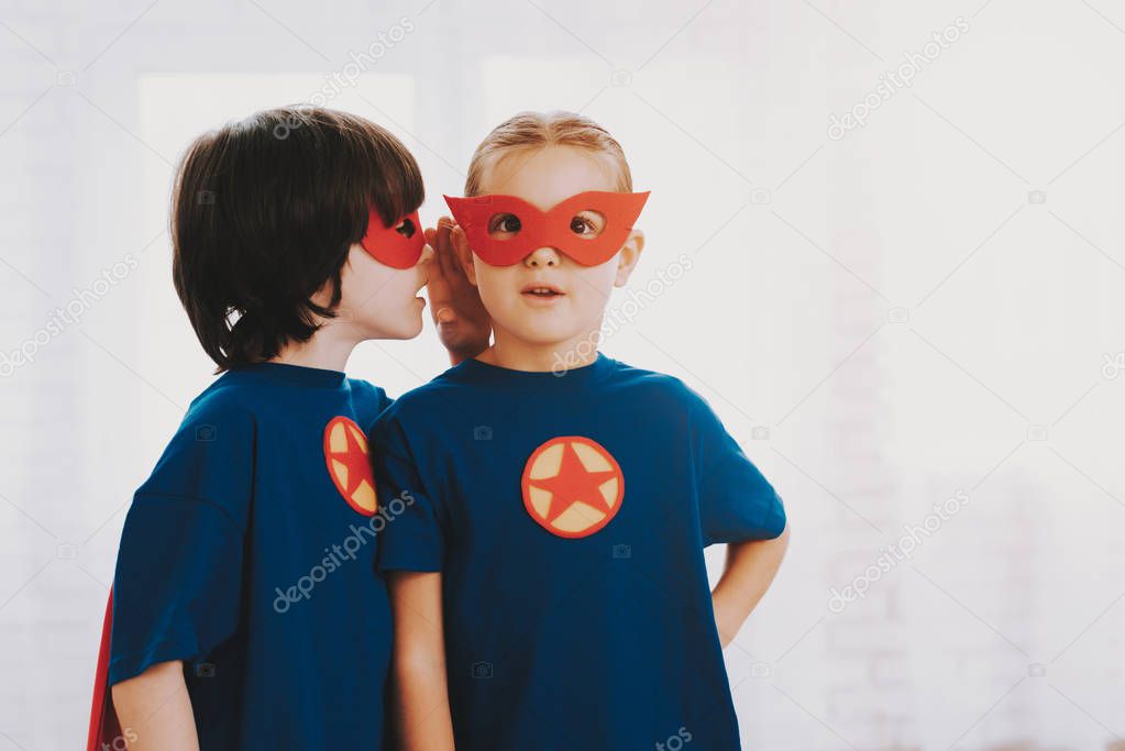 Children In A Superhero Suits. Posing Concept. Masks And A Raincoats. Bright Room. Resting Together. Save The World. Get Ready. Secret Whispering. Happy Childhood. Brother And Sister. Young Leaders.