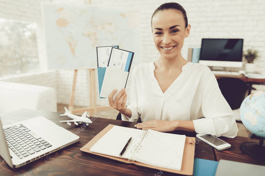 Travel Agent Holding Tickets in Travel Agency. Smiling Woman in Office. Consultant in Travel Office. Airplane Tickets. Modern Office. Holding Tickets in Hand. Modern Office. Tourism Concept.