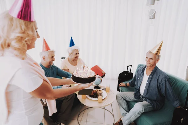 Old Couple Celebrating Birthday before Departure. Senior Person in Airport. Tourism Concept. Old Couple in Voyage. Celebrating Birtsday. Vacation for Pensioner. Travelers on Vacation.