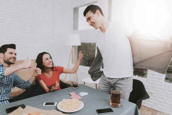 Young Smiling People Have Fun on Party at Home. Playing Games. Eating Snacks. Indoor Fun. Young Smiling Girl. Young Smiling Guy. Sitting at Table. Party with Friends. Indoor Activities Concept.