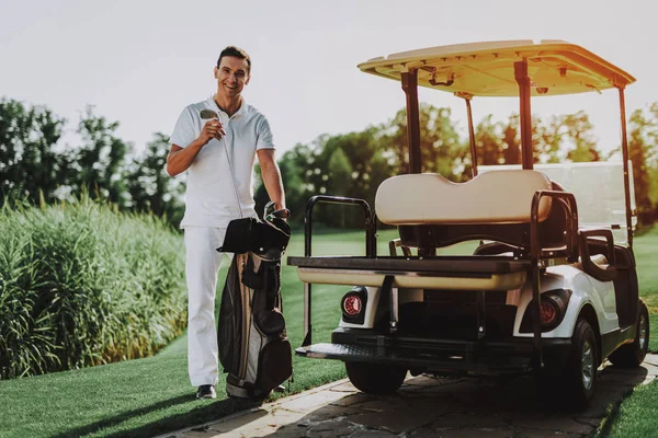 Young Man in White Shirt using Cart on Golf Field. Happy Young Man. Driver with Car. Healthy Lifestyle Concept. Golf Club. Sports in Summer. Vehicle on Field. Family Holiday. Outdoor Fun in Summer.