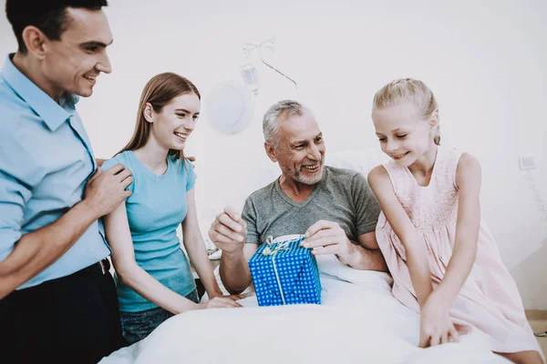 Man and Young Girl in Hospital with Old and Happy Man. Young Man in Hospital with Young Girl. Health Girl and Young Man in Clinic. Family for Old Man for Good Health.Care for Aged Man.