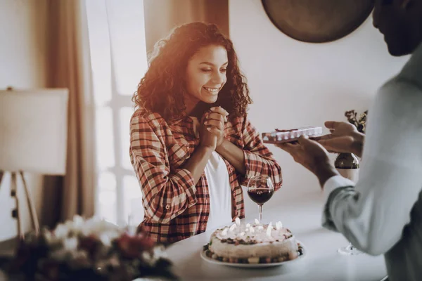 Young Afro American Couple Date. Present Concept. Beautiful Romantic Moment. Surprised Girl. Box With A Gift. Family Holiday. Happy Sweethearts. Cheerful Lovers. Weekend Resting On Kitchen.