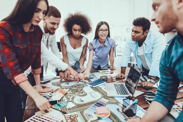 Teamwork. Spend Brainstorming. Different Nationalities. Tam of Young People. Generate Idea. Color. Design. Project. Cooperation. Group. Young. Designers. Work. Table. Large Bright Office.