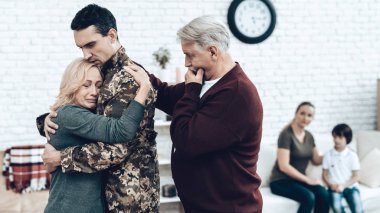 A Man Goes To Military Service. Saying Goodbye. Leaving To Army. Farewell With Family. Camouflage Uniform. Parent Hanging. Feelings Showing. Guard Of Peace. Patriotic Decision. Soldier Emotion. clipart