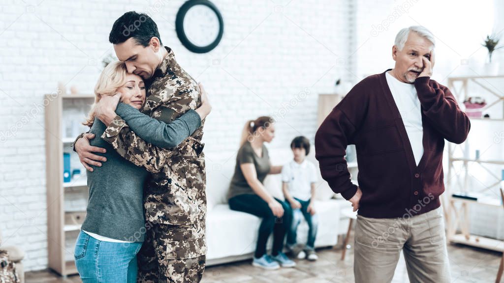 A Man Goes To Military Service. Saying Goodbye. Leaving To Army. Farewell With Family. Camouflage Uniform. Parent Hanging. Feelings Showing. Guard Of Peace. Patriotic Decision. Soldier Emotion.